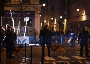 Sejumlah polisi berjaga-jaga di salah satu lokasi "nonton bareng" pertandingan Piala Dunia 2022 Qatar antara Belgia kontra Maroko di Brussel, Minggu (27/11/2022). Sekelompok fans mengamuk dan menyerang polisi setelah Belgia kalah 2-0 dalam pertandingan itu. (AFP/KENZO TRIBOUILLARD)