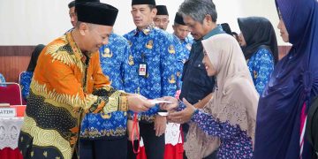 Ketua DPRD Kota Blitar, dr Syahrul Alim memberikan secara simbolis kartu rastrada non-tunai kepada warga penerima manfaat.